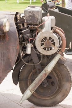 Vintage car engine on the front wheel.