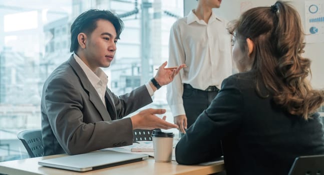 Asian business team is meeting for a project to establish and plan. Discussion of graphs and chart data analysis business finance graph and accounting concept.