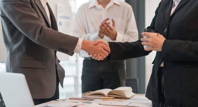 Young asian business shaking hands successful making a deal, business woman handshake. Business partnership meeting handshake concept.