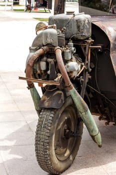 Vintage car engine on the front wheel.