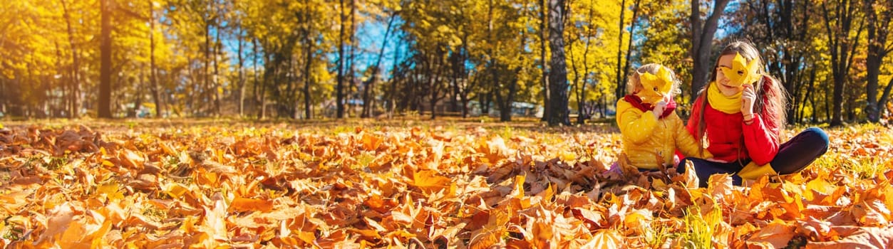 Autumn child in the park with yellow leaves. Selective focus. Kid.