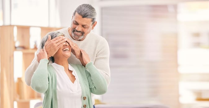 Eyes closed, surprise and elderly couple in a retirement home and living room together. Mockup space, present and senior people in marriage with love, support and care with romance and happy laugh.