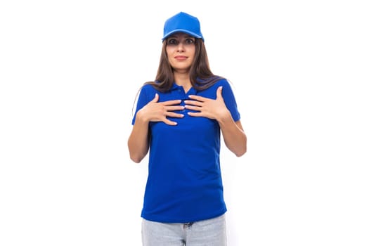 charming young caucasian brunette woman in uniform t-shirt and cap with space for brand print.