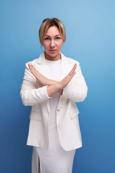 young well-groomed blond boss woman in a white jacket crossed her arms.