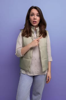 surprised dumb brunette young woman in vest and shirt.