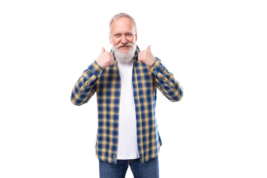 nice well-groomed mature gray-haired man with a beard in a shirt on a white background with copy space.