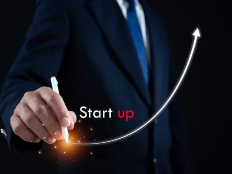 Businessman presses the pen at the starting point to start a business. Startup concept. Business concept.