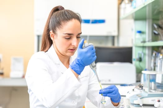 Young woman scientist in a research laboratory creating scientific experiment, laboratory concept