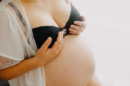 Young pregnant woman touching on her breast during a pregnancy, healthcare concept