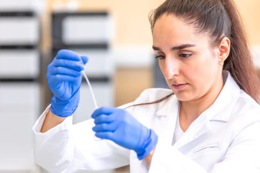 Young woman scientist in a research laboratory creating scientific experiment, laboratory concept