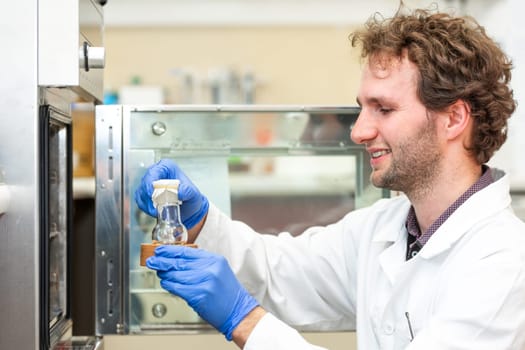 Young scientist in a research laboratory creating scientific experiment, laboratory concept