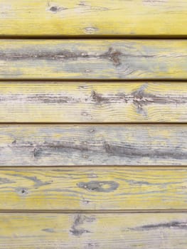 Yellow painted old wooden wall. Yellow background.