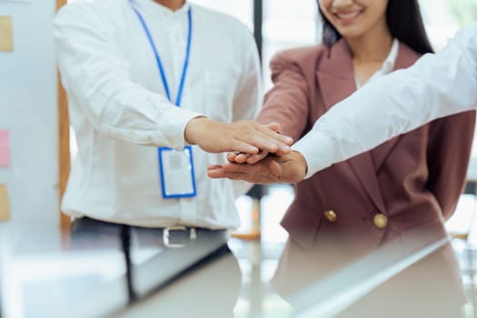 Closeup hand of Businesspeople unity between business people with their hands stacked for project development and innovation.