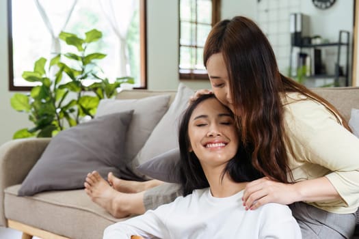 LGBTQIA lesbian gay couple playing guitar and singing with romantic feelings at home.