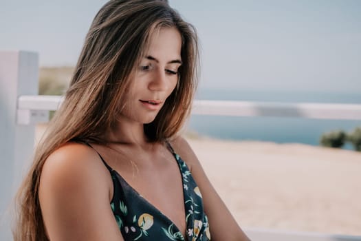 Happy woman portrait in cafe. Boho chic fashion style. Outdoor photo of young happy woman with long hair, sunny weather outdoors sitting in modern cafe