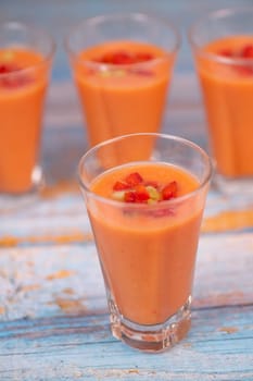 Healthy verrines with tomato soup on blue background, High quality photo