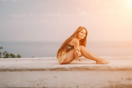 Woman park yoga. Side view of free calm bliss satisfied woman with long hair standing in morning park with yoga position against of sky by the sea. Healthy lifestyle outdoors in park, fitness concept