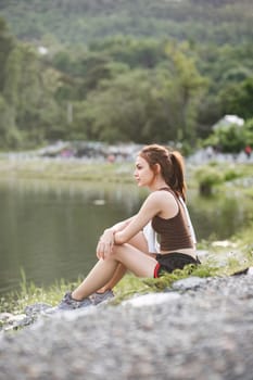 portrait of beautiful asian woman Wipe off your sweat after an evening jog in the park..