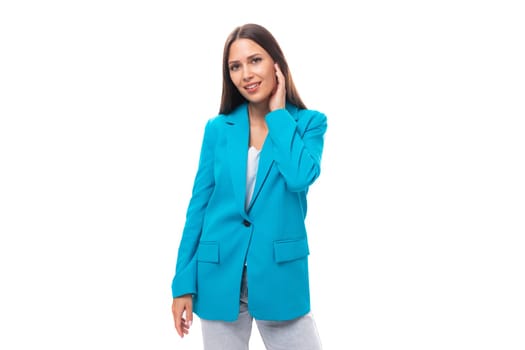 young well-groomed office worker woman with black straight hair in a blue business jacket on a white background with copy space.