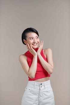 Surprised young woman excited cover open mouth and look side happy laughing 