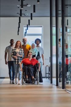 A diverse group of young business people walking a corridor in the glass-enclosed office of a modern startup, including a person in a wheelchair and a woman wearing a hijab, showing a dynamic mix of innovation and unity