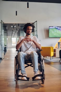 A businessman in a wheelchair occupies a hallway within a modern startup coworking center, embodying inclusivity and determination in the business environment.