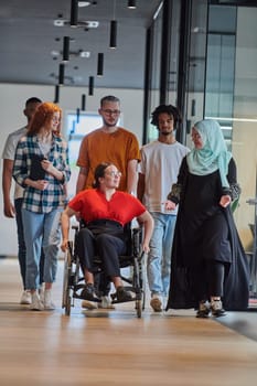A diverse group of young business people walking a corridor in the glass-enclosed office of a modern startup, including a person in a wheelchair and a woman wearing a hijab, showing a dynamic mix of innovation and unity