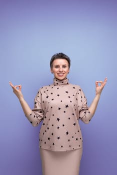 pretty caucasian young woman with short haircut dressed in a beige suit with a hollywood smile.