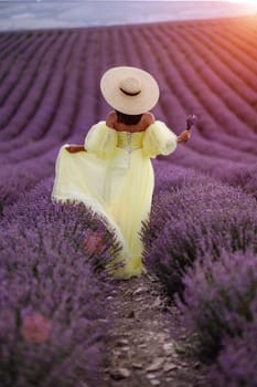 Woman lavender field. Lavender field happy woman in yellow dress in lavender field summer time at sunset.
