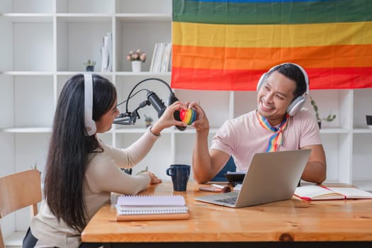 Men and women hold rainbow hearts, a symbol of the LGBT community, in support of gender equality..