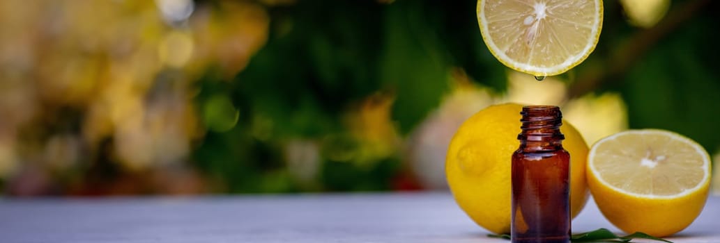 lemon essential oil and lemon fruit on a wooden white board. Selective focus