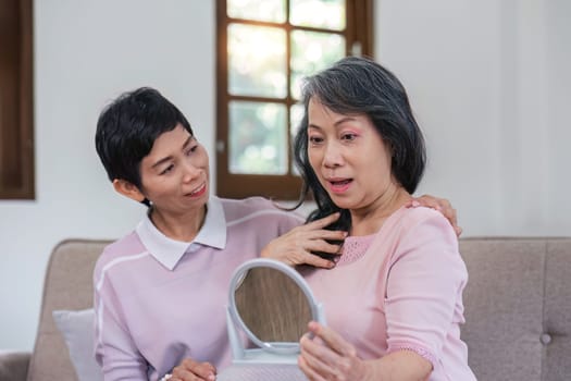 An elderly woman happily spends her free time make up with friends in the living room..