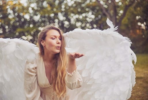 Beautiful girl dressed as an angel in the garden.