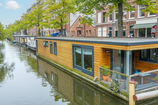 Netherlands. Cloudy summer day in Amsterdam. Houseboats on the canal