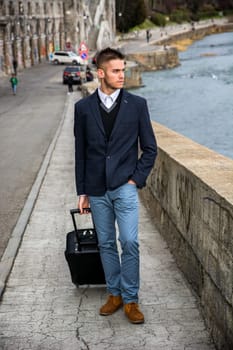 A man in a suit and tie holding a suitcase