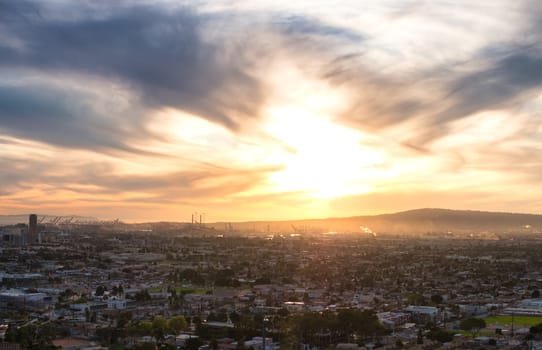 The sun is setting over a city and hills. Photo of a breathtaking sunset over the iconic cityscape of Los Angeles, California