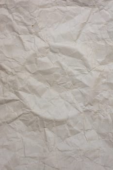 Vertical background from old crumpled paper, a circle is squeezed out in the middle. Backdrop