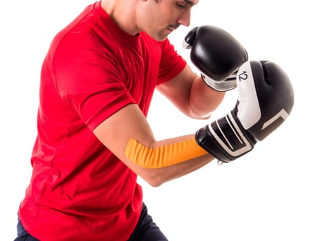 A man in a red shirt and black and white boxing gloves