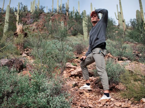 A man standing on top of a rocky hillside