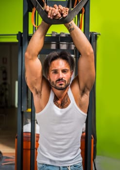 man leaning from forklift holding handle above his head. Photo of a man leaning from forklift