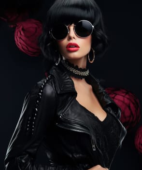 Stylish fashionable woman in black leather clothing from famous brands