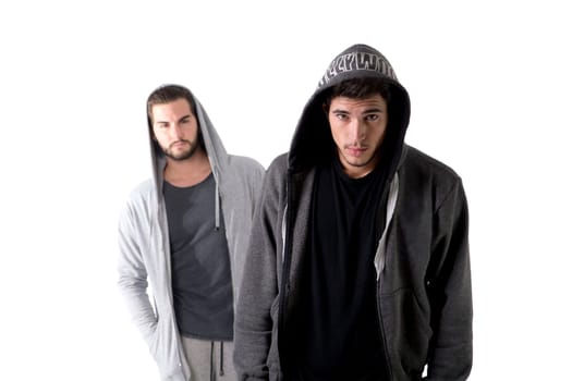 Two seemingly dangerous thugs standing next to each other in front of a white background