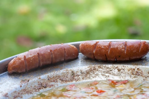 Baked sausages in traditional croatian dish kotlovina