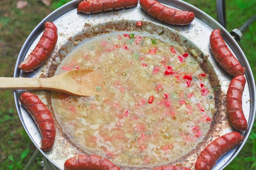 Baked sausages in traditional Croatian dish kotlovina.