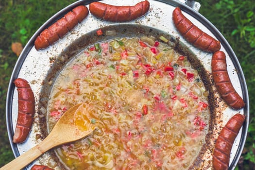 Baked sausages in traditional Croatian dish kotlovina.