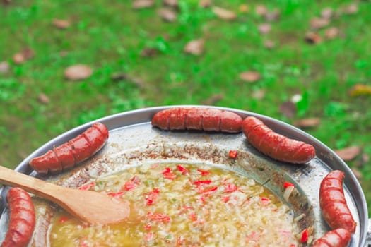 Baked sausages in traditional Croatian dish kotlovina.