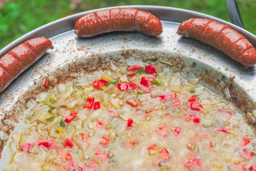 Baked sausages in traditional Croatian dish kotlovina.
