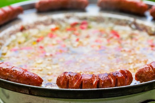 Baked sausages in traditional Croatian dish kotlovina.