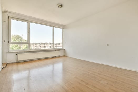 an empty room with wood flooring and large windows looking out onto the cityscapearrons com