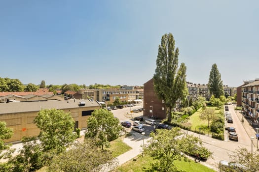 an urban neighborhood with lots of trees and houses in the distance, on a clear blue sky day stock photo